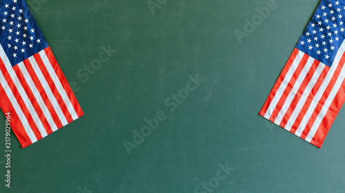 United States flag on green chalkboard creating educational patriotic background with open copy space and symmetrical composition