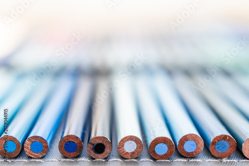 close-up of blue colored pencils neatly lined up in pencil case, concept of creativity and drawing