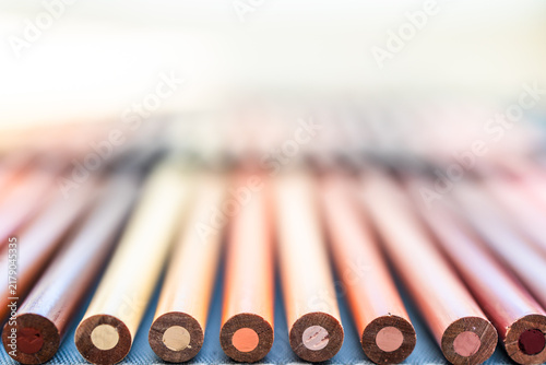 close-up of skin tone colored pencils neatly lined up in pencil case,  concept of creativity and drawing