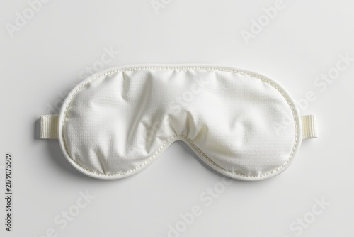 White silk sleep mask with an elastic strap, designed to block light and enhance restful sleep.