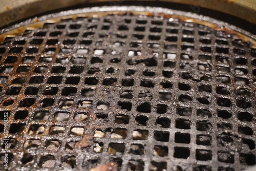 Close Up of Dirty Greasy Metal Mesh Grill Grate After Barbecue Cooking