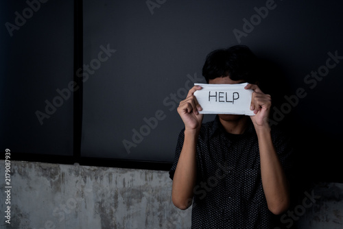 Фотография Bullying Victim Asking for Help with HELP Message Covering Face