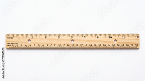 Wooden ruler showing both metric and imperial measurement scales centered horizontally isolated on white background