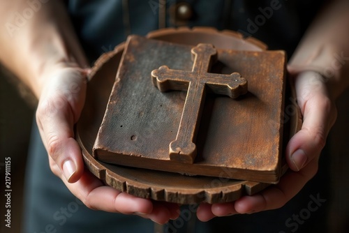 Rustic wooden plate holds ancient cross & worn bible , jesus, lent, salvation