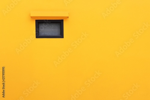 Yellow concrete wall with fixed window background