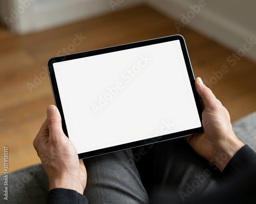 Man holding touch screen tablet device for mockup