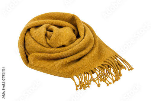 Fotografie Soft mustard yellow wool scarf, neatly rolled and featuring delicate fringes, is