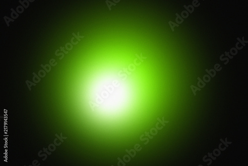 Abstract glowing soft green light orb centered on a deep black background, with a smooth, radial gradient and, subtle luminous hazy effect