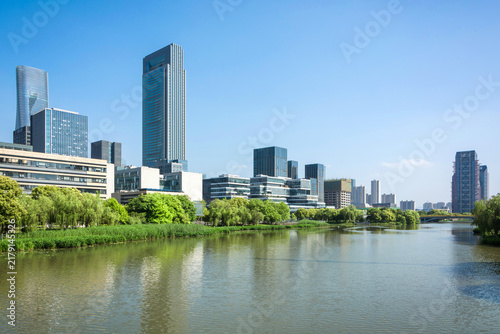 Vibrant City Skyline Reflected in Calm Waters on a Sunny Day