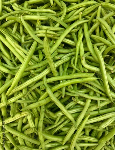 Full frame top down view of a large pile of fresh green string beans packed together.