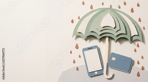 Paper cut illustration of an umbrella protecting a smartphone and credit card from rain, symbolizing financial security and mobile banking insurance