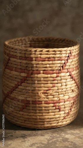 Handwoven rustic wicker basket with red geometric pattern