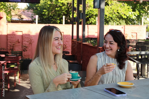 Two friends Enjoying Coffee at outdoor cafe