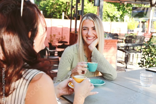 Two friends Enjoying Coffee at outdoor cafe