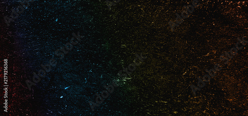 Abstract dark textured surface with colorful lighting effects and distressed worn details