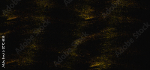 Dark black and gold grunge texture background with rough chalk or pastel strokes and distressed surface