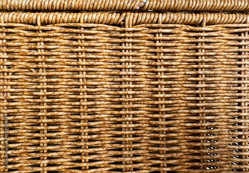 Detail of brown handmade woven basketwork texture with top edge for background.
