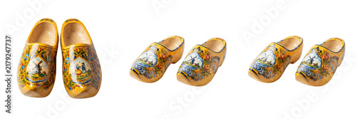 Traditional Dutch wooden clogs painted with windmill landscapes yellow handmade wooden shoes typical Netherlands souvenir folk footwear isolated on white background stock photo