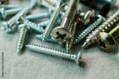 Quadro su tela Mixed Phillips Screws Scattered Across a Fabric Surface