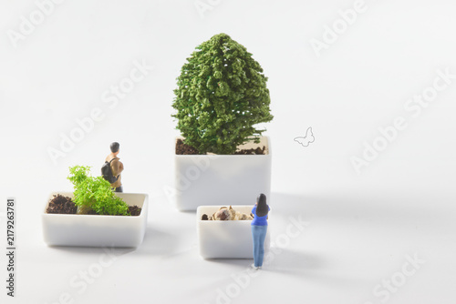 Biodiversity and species diversity concept with miniature people, plants and butterfly