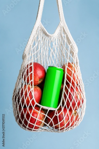 Cold drink can mockup inside string shopping bag with fresh apples bright studio shot