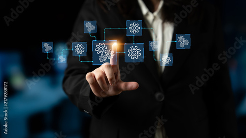 Фотография Business Professional Interacting with Digital Gears Symbolizing Automation and Process Improvement in Modern Work Environment