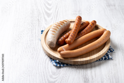 Traditional German sausages on white wooden table. Copy space