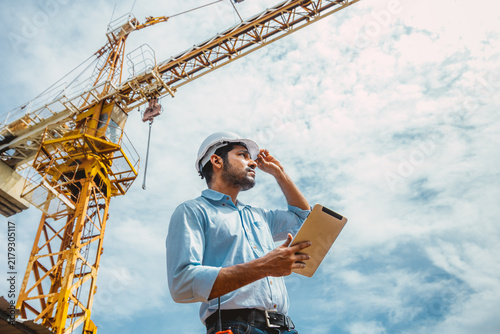 Indian Asian Engineer Worker Holding Tablet Inspection Construction Site Tower Crane