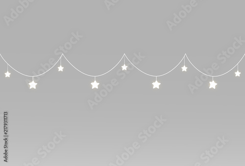 Festive star garlands with delicate white light suspended on two gently curved hanging strings above