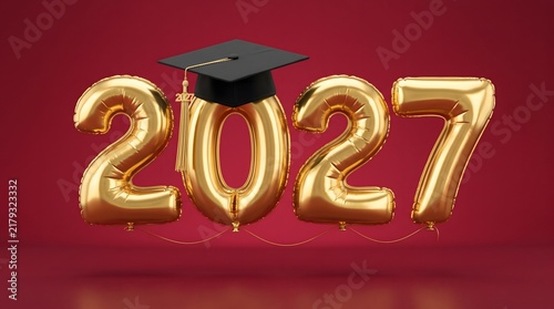 Shiny golden foil balloons carefully shaped to display the year two thousand twenty seven with a classic graduation cap resting on top against a