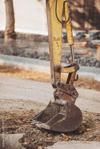 Construction equipment at work on urban infrastructure renovation project in a bustling city