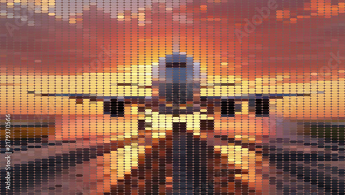 Large commercial airplane flying over urban buildings at sunset