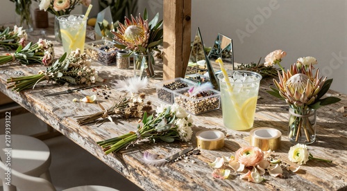 Floral workshop arranging bouquets on rustic wooden table