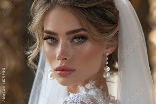 Closeup beautiful bride with pearl earrings and lace veil high end wedding beauty portrait, warm bokeh light.