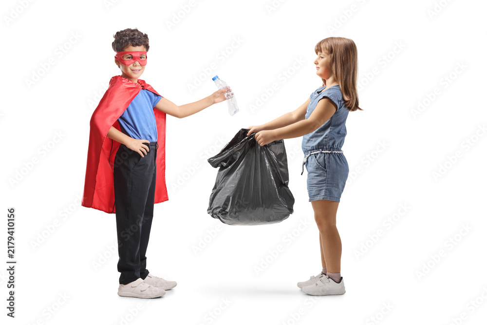 Fototapeta premium Superhero child collecting plastic bottles for recycling