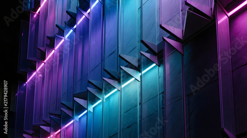 Futuristic glass architecture facade glowing with blue and purple