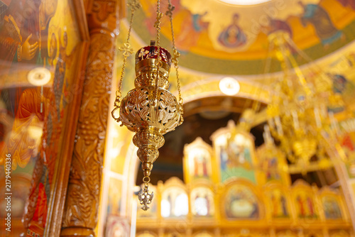 Obraz na płótnie Golden hanging vigil lamp inside historic church, religious sanctuary and faith
