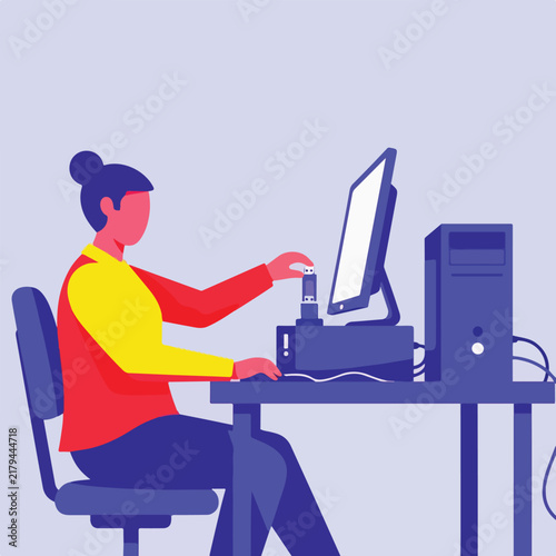 Person connecting USB drive to computer at desk