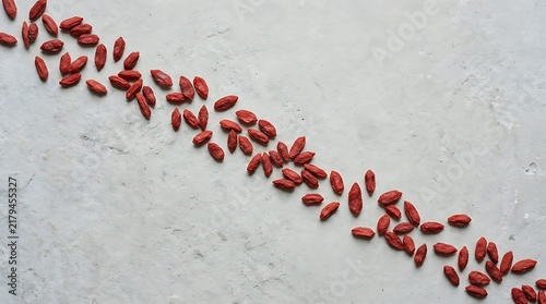 Goji berries top view on a light background, organic superfood ingredients arranged diagonally for healthy food