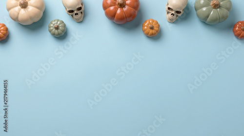 Spooky Halloween Flat Lay Border With Pumpkins And Skulls On Blue Background