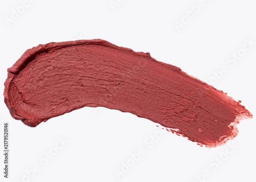 Fotografie Terracotta lipstick swatch on white surface