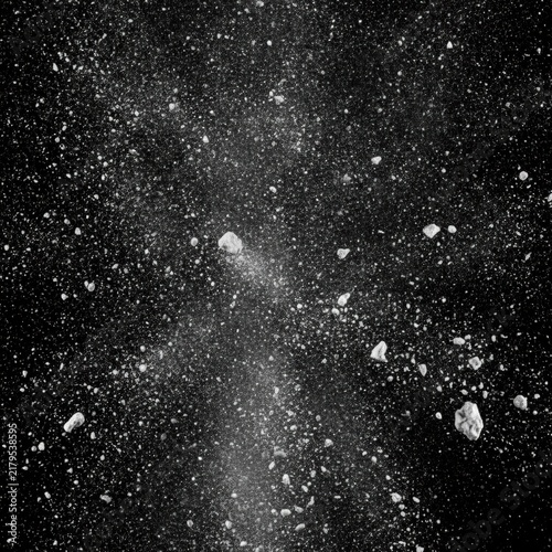 Abstract Black and White Explosion of Particles and Rocks in Deep Space, concept of cosmic chaos and creation
