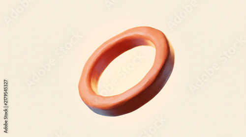 Smooth copper ring or toroid shape floating on a cream background with metallic band orange circle geometric form smooth surface