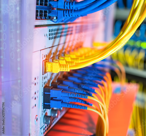 Foto Fiber Optic cables connected to optic ports and UTP, Network cables connected to ethernet ports