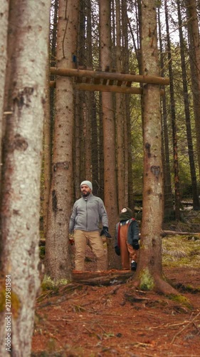 Father and son exploring an ancient forest together