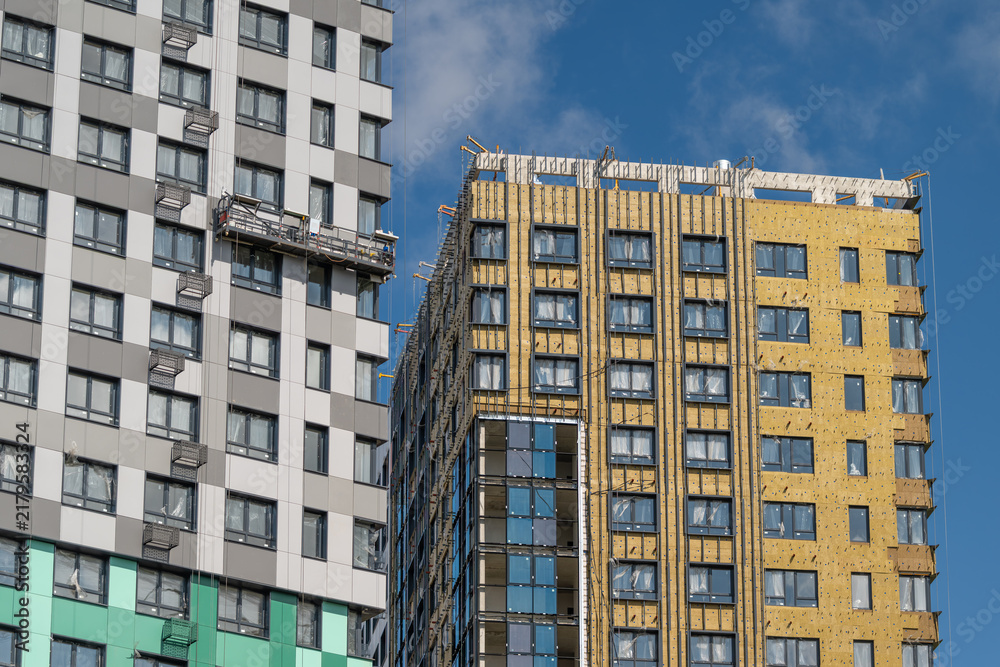 Fototapeta premium Modern skyscrapers showcase unique architectural designs under a clear blue sky in a vibrant urban setting