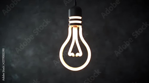 A Single Glowing Edison-Style Light Bulb Hanging from a Cord Against a Dark Textured Background