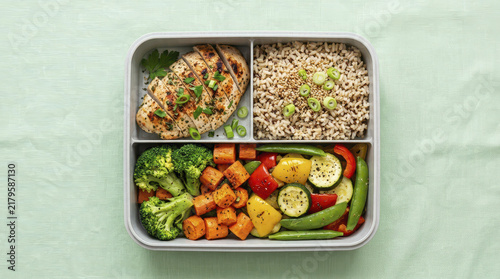 High protein meal with grilled chicken, high fiber brown rice, and colorful vegetables in bento box