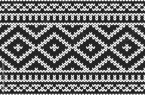 Black and white knitted geometric pattern with traditional textile ornament design.