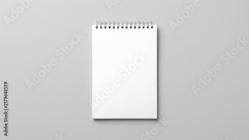 Blank spiral notebook mockup positioned vertically on a minimal grey surface